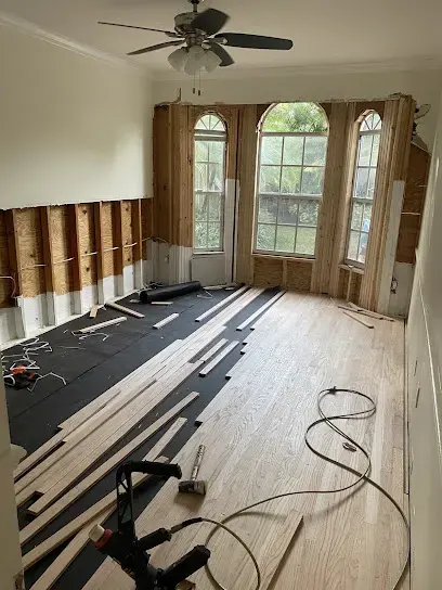 Flooring pulled up and flood cuts along the walls of a west Pasco great room during drying