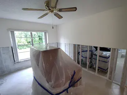Furniture wrapped in plastic beside a flood cut in a west Pasco home