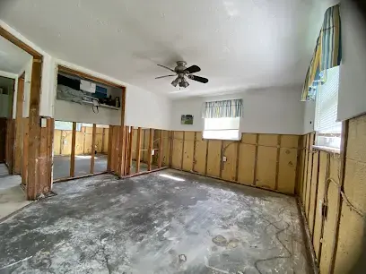 Family room with drywall cut away to the studs after flooding on the Gulf coast