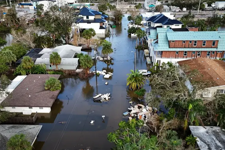 Canal-front Gulf coast homes standing in storm surge floodwater after a hurricane